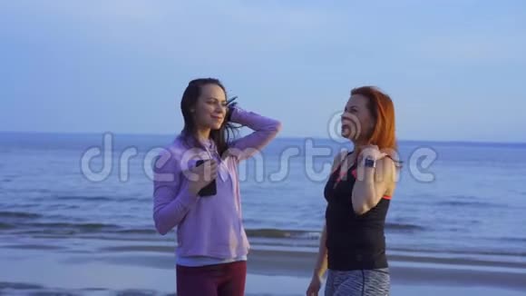 两个穿着运动服的中年妇女在一条河的沙岸上情绪化地交谈完成后妇女进行交流视频的预览图