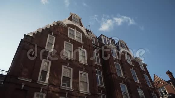 在阳光明媚的日子里典型的英国红砖房映衬着蓝天行动传统的英语建筑视频的预览图