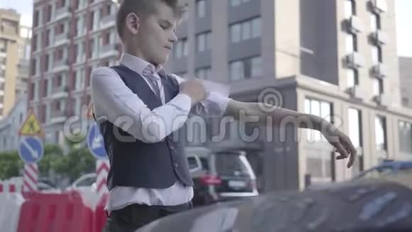 小男孩卷起袖子举起汽车的引擎盖自信的男孩要自己修理汽车视频的预览图