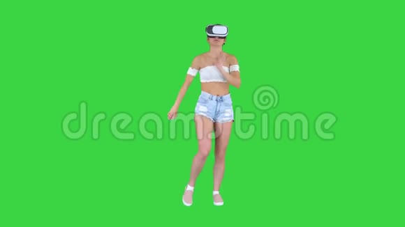 可爱的女孩跳舞而她有她的VR舞蹈时间在绿色屏幕Chroma键视频的预览图