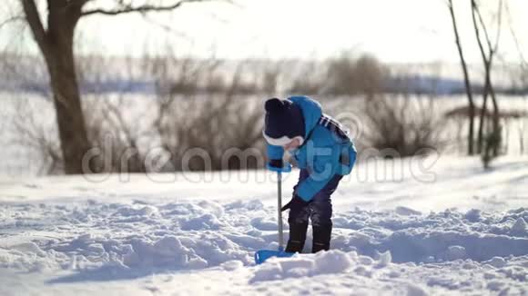 小男孩在冬天铲雪视频的预览图