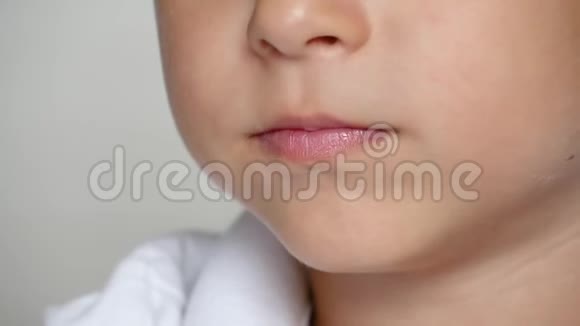 快乐的孩子咬掉一块粉红色的饼干或杏仁饼干快关门孩子吃东西婴儿食品的概念视频的预览图