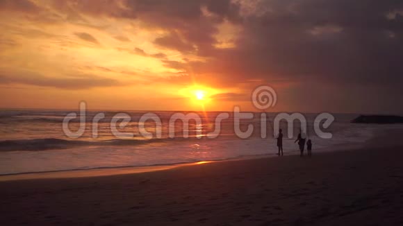日落时分在海滩上的渔夫和儿子视频的预览图