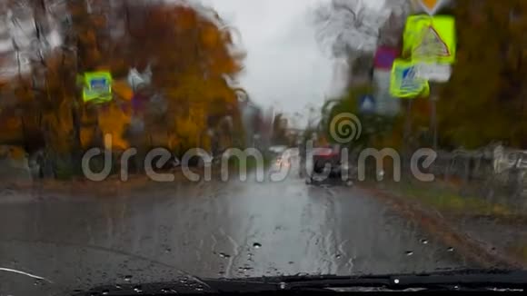 在雨天的秋日一辆闪烁灯光的警车在街上疾驰视频的预览图