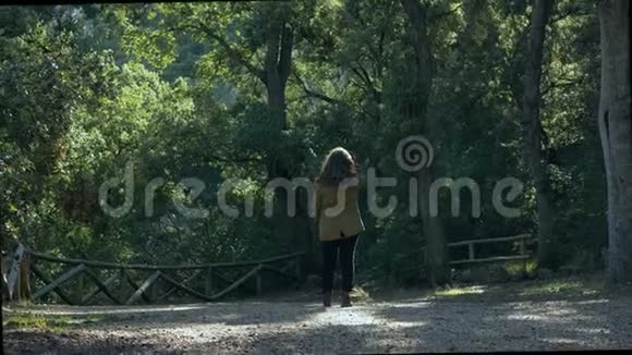 年轻女子被美丽的森林包围视频的预览图