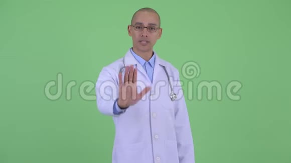严肃的秃头多民族医生停止手势视频的预览图