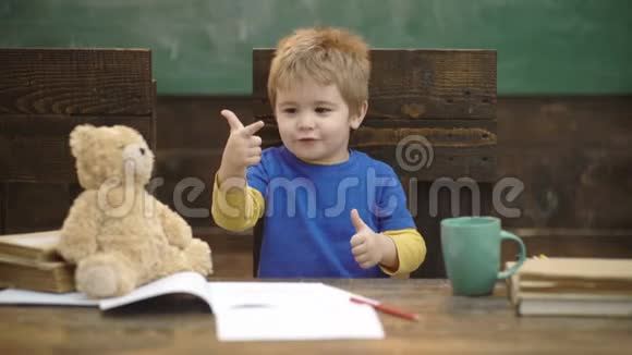 小男孩数着有绿色黑板背景的手指回学校去教育儿童和学校概念视频的预览图