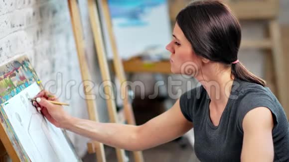 迷人的年轻女画家用灰色铅笔画中等特写视频的预览图