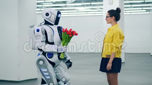 一个机器人把红色郁金香送给一个女孩她拥抱它视频的预览图