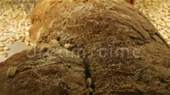 在面包店里黑麦谷物的特写落在棕色面包上库存录像美味的糕点概念视频的预览图