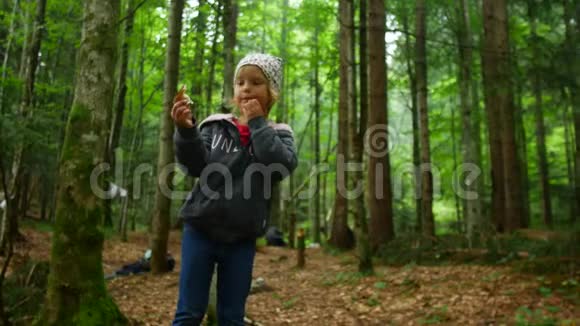 小女孩在森林里发现了一个蘑菇视频的预览图
