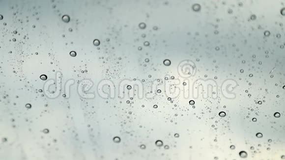 雨滴滴在汽车特写的挡风玻璃上挡风玻璃的纳米涂层视频的预览图