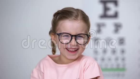 喜笑颜开的戴眼镜的小女孩大笑积极的视力治疗效果视频的预览图