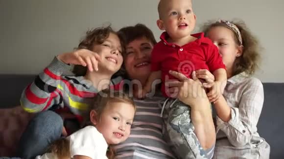 肖像室内幸福祖母和她的四个孙子一个幸福的大家庭两个姐妹和两个兄弟视频的预览图