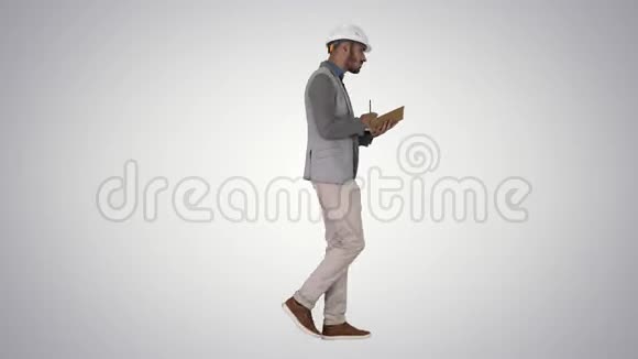 穿休闲服装和安全帽的阿拉伯男人在梯度背景上写下清单视频的预览图
