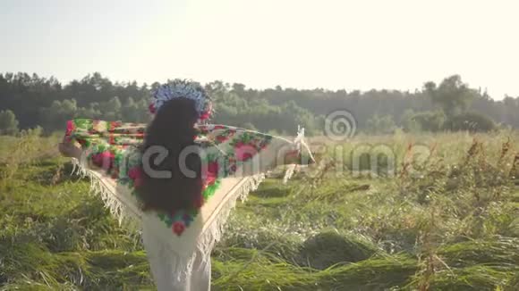 有趣的超重妇女脱下传统披肩落在夏季田野的高草上美丽的风景视频的预览图