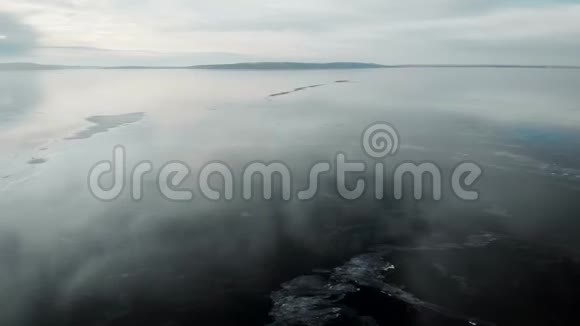 这一个鸟瞰图摄像机在新冻结的河流上快速移动冰很光滑有裂缝和视频的预览图