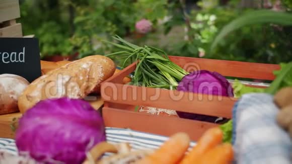在农场市场的摊位上拍摄新鲜的生果草本植物和蔬菜的特写镜头视频的预览图