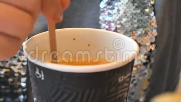 女人的手把糖搅到咖啡馆的杯子里视频的预览图
