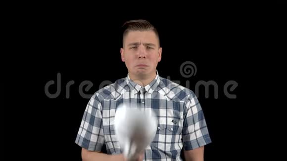 一个年轻人摘下面具脸上流露出悲伤的情绪穿衬衫的伤心人一个人藏着脸视频的预览图