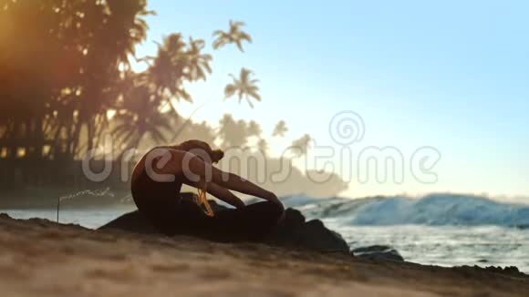 令人兴奋的女士在海洋烧香棒附近做瑜伽视频的预览图
