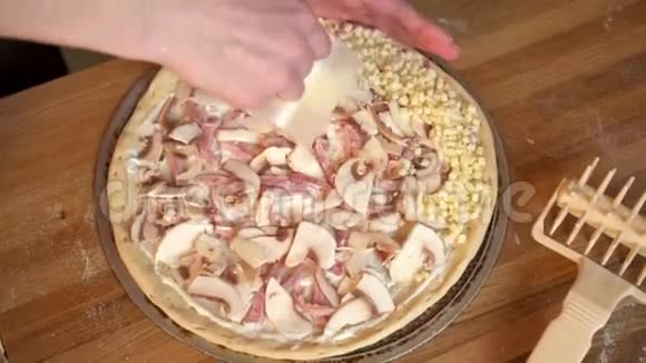 女人撒奶酪做披萨的特写镜头视频的预览图