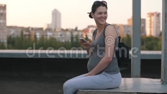 微笑着带着聪明的孕妇视频的预览图