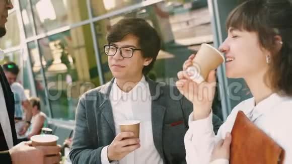 商务团队两男一女一起在外面喝咖啡视频的预览图
