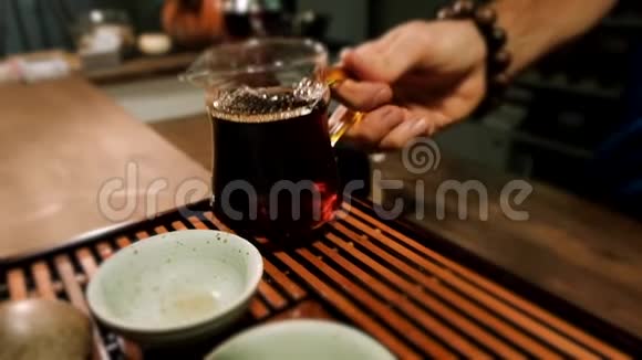 中国仪式主持人倒出琥珀色的发酵茶视频的预览图