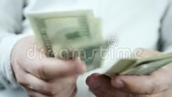 手工计算一百美元或一百美元面额的钞票视频的预览图
