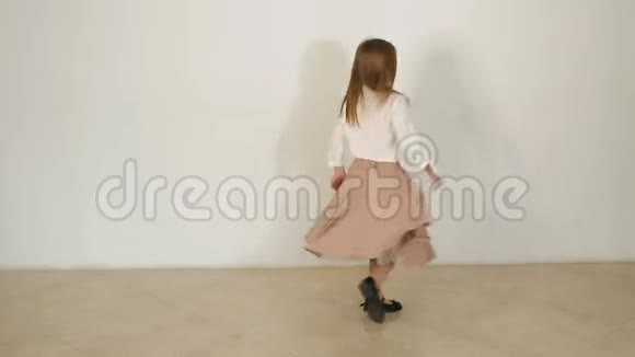 一个穿着长裙的小女孩在工作室里摆姿势她绕着自己转视频的预览图