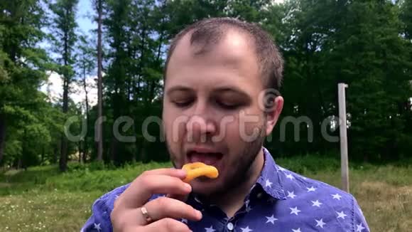 一个在外面吃玉米饼片的年轻人视频的预览图