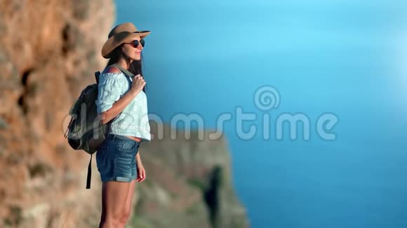 可爱的旅游时尚女性与背包站在山顶放松享受自然视频的预览图
