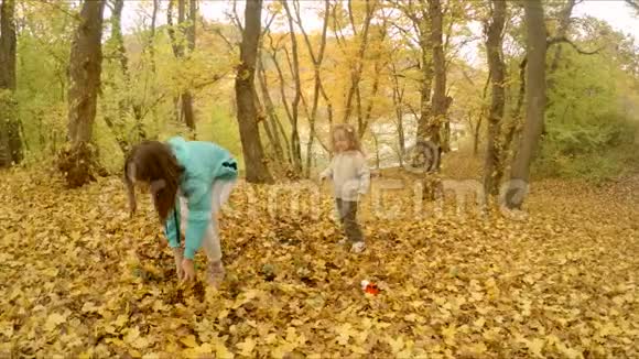 孩子们在森林里玩秋天的树叶视频的预览图