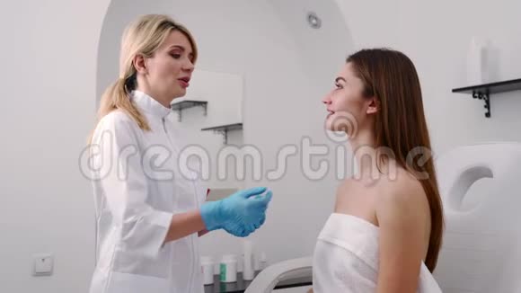 整形外科医生或美容专家检查女性面部用手触摸检查后愈合的皮肤视频的预览图