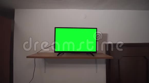 在一间又旧又黑的房间里有绿色屏幕电视视频的预览图
