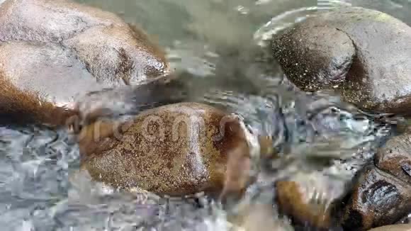 水流过石头石头被河水冲刷水流过自然岩石水流平稳视频的预览图