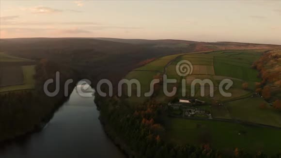 日落时分英国乡村晴朗的天空中一座古老农舍的空中镜头视频的预览图