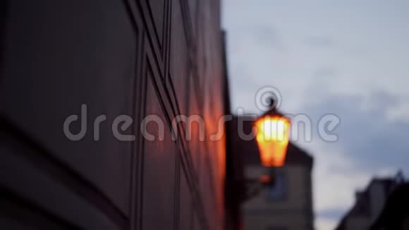 街墙锻铁灯笼燃烧着黄色浪漫的光模糊傍晚浪漫的气氛视频的预览图