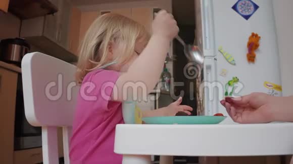 两岁的金发碧眼小女孩在吃饭4K镜头视频的预览图