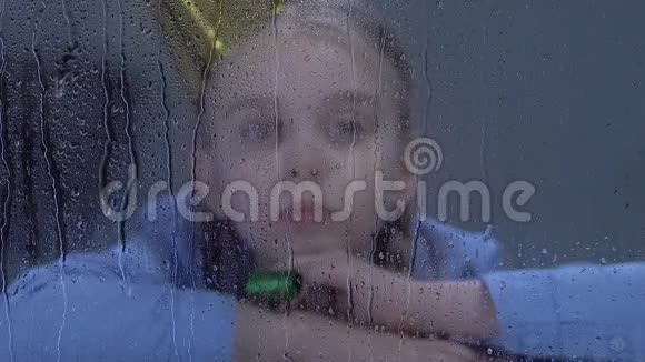 沮丧的女孩在雨窗后玩派对鼓风机欺负受害者视频的预览图