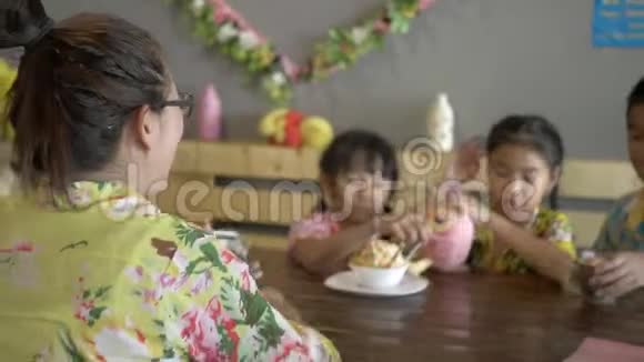 亚洲家庭吃冰淇淋在厨房房间用智能手机自拍视频的预览图