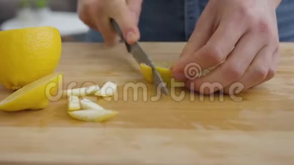 年轻女人用锋利的刀把果皮和柠檬分开健康观念视频的预览图