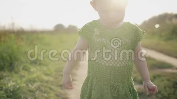 在阳光明媚的日子里心烦意乱的女婴沿着田野小径散步视频的预览图