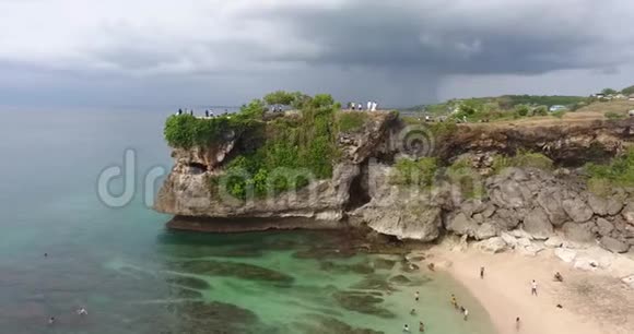 巨大的悬崖海岸上有洞穴很多人在散步4K视频的预览图