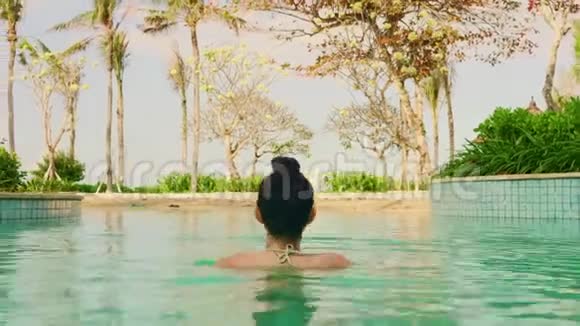 年轻快乐美丽的穿着比基尼享受暑假假期的亚洲女性在豪华酒店享受自然生活方式视频的预览图