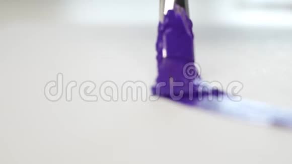 油漆工使用回火工艺用刷子和紫罗兰色油漆视频的预览图