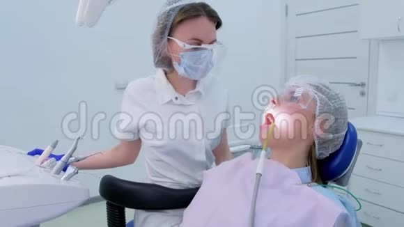 牙科保健员用超声波清洗把牙齿和水浇给妇女视频的预览图