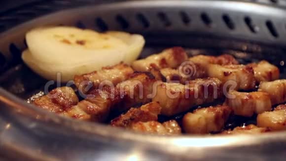 把烤猪肉和洋葱放在火烤架上烤出来视频的预览图