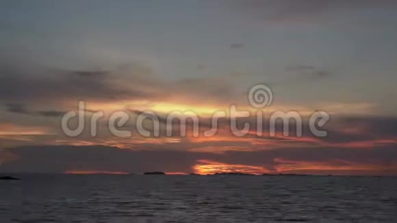 日落的天空在海面上随着大量的云从橙色的天空转移到黑暗中视频的预览图